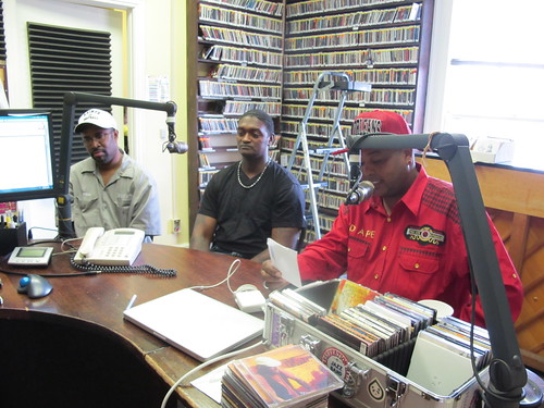 Phil and Yancy stand by while Action talks about Mardi Gras Indian practices during Talkin It to the Streets. photo by Briana Prevost