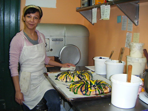 Julia stands next to Cake Cafe's first two king cakes of the season! photo by Briana Prevost